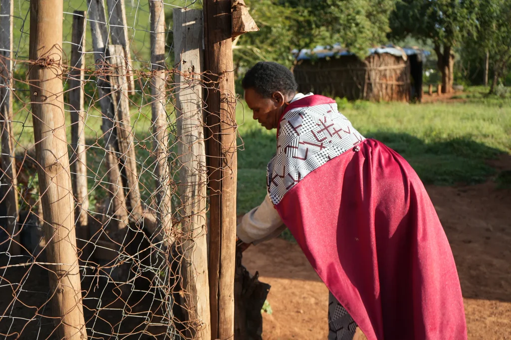 Emma Sintent closing a livestock pen at her home in Namuncha Ranch.